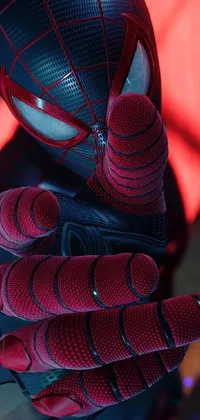 This phone live wallpaper features a close-up of a superhero character wearing a vibrant Spider-Man suit in red and blue colors