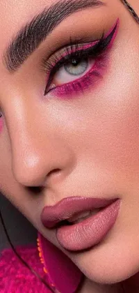 Looking for a stunning live wallpaper for your phone? Look no further! Our phone live wallpaper features a close-up shot of a glamorous woman with captivating magenta makeup and smoky pink eyeshadow