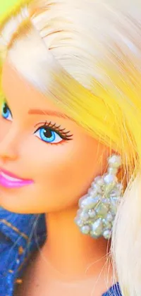 This phone live wallpaper features a close-up shot of a Barbie doll with blonde hair, dressed in jeans, adorned with jewels, and set against a vibrant, high saturation pop art backdrop