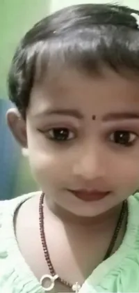 This charming phone live wallpaper showcases a close-up of a child wearing a necklace