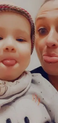 This live wallpaper showcases a delightful scene of a woman taking a selfie with a baby against a picture-in-picture background mimicking Instagram posts