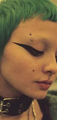 This phone live wallpaper features an attention-grabbing close-up of a person with stunning green hair, adorned with small studded earrings and a black choker necklace, showcasing an edgy aesthetic