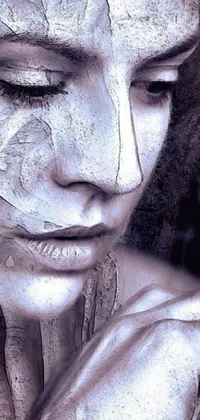 This phone live wallpaper depicts a woman wearing white paint on her face