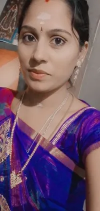 This phone live wallpaper features a stunning woman wearing a blue sari, posing for a professional profile picture