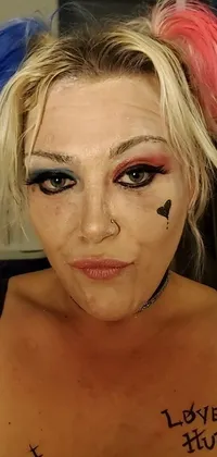 Looking for a bold and edgy live wallpaper with a messy edge? Check out this close-up of a person with striking makeup, modeled after a popular comic character