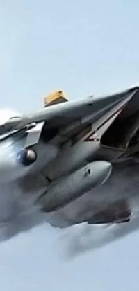 This phone live wallpaper depicts a fighter jet in stunning detail flying through a clear blue sky