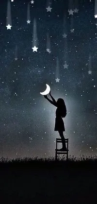 This live phone wallpaper features a stunning image of a person standing on a chair under a night sky