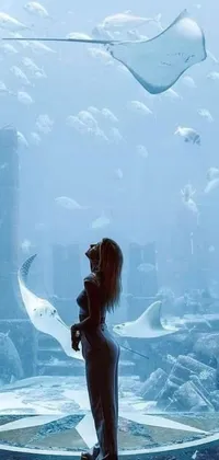 This ocean-themed live wallpaper depicts a surreal scene of a woman in front of an intricately designed fish tank
