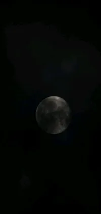 This phone live wallpaper features a full moon shining in a dark sky