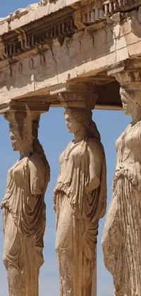 This live phone wallpaper showcases a group of intricate stone statues
