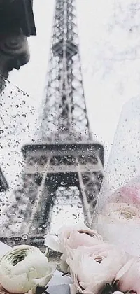 This phone wallpaper showcases a gorgeous bouquet of flowers set against the iconic Eiffel Tower in Paris