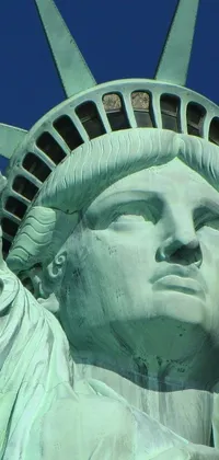 This stunning live wallpaper features a close-up view of the head of the iconic Statue of Liberty