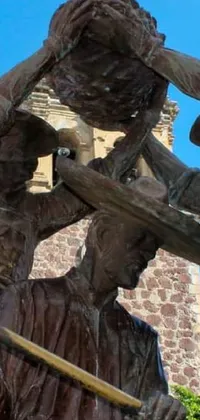 This live wallpaper showcases a striking statue set against a stunning building and sky background, captured in vibrant Mexico destination Tlaquepaque