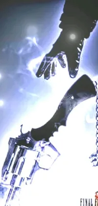 This phone live wallpaper depicts a striking close-up of a gloved hand holding a gun, against a backdrop of shiny jewelry and a backdrop of shackles