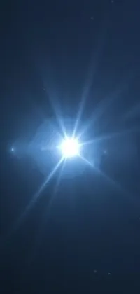 This stunning phone live wallpaper features a bright star shining in a dark, velvety blue sky