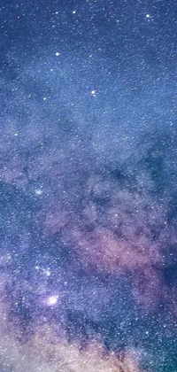 This live wallpaper depicts a stunning night sky filled with twinkling stars and beautiful space art in shades of purple and blue