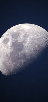 This striking live wallpaper features a close-up view of a half-moon positioned towards the left side of the screen