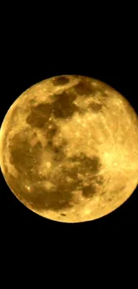 This Mobile Live Wallpaper features an Animated Full Moon with a Yellow Glowing Face, against a Twinkling Dark Sky with Stars and Planets in the Background