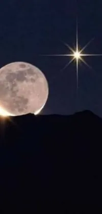 This phone live wallpaper showcases a stunning full moon and a sparkling star in the clear night sky