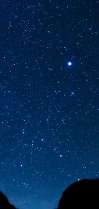 Enjoy the mesmerizing beauty of a star-filled night sky with this captivating live wallpaper for your phone