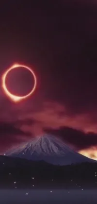 This phone live wallpaper showcases a stunning ring of fire over a mountain during an eclipse