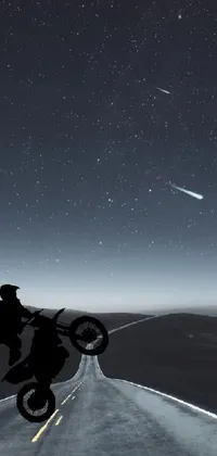 This phone live wallpaper showcases a thrilling image of a man zooming down a deserted, moonlit road on his motorcycle