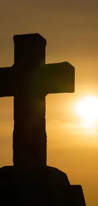 This live wallpaper showcases a stunning silhouetted cross set against a breathtaking sunset