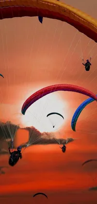 This live wallpaper renders a spectacular sunset scene where several people with parachutes are parasailing in the sky, amidst a bustling city filled with flying cars and planes