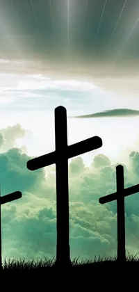 Experience a captivating and inspiring live phone wallpaper featuring a picturesque scene of three crosses situated on a hill, spotlighted by a neon cross, set against a dramatic cloudy sky