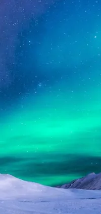 This phone live wallpaper features a serene snow-covered slope with two people enjoying its beauty