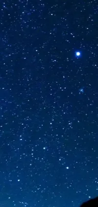 This stunning live wallpaper features a night sky filled with twinkling stars, planets, and a beautiful picture of a far-off galaxy with colorful nebulas