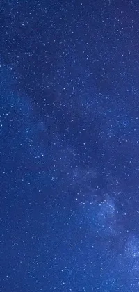 Looking for a mesmerizing and peaceful live wallpaper for your phone screen? Look no further than this stunning night sky theme! With a dark blue and blue light background, this wallpaper features countless twinkling stars shining brightly against the smooth sky, creating an enchanting and dreamy ambiance