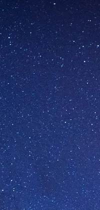 This phone live wallpaper captures the essence of a starry night sky with a microscopic photo of the cosmos, featuring a minimalistic design and a stunning close-up shot from above