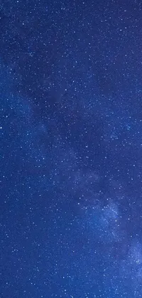 This mesmerizing phone wallpaper features a stunning image of a night sky, filled with an array of beautiful stars of all sizes and colors