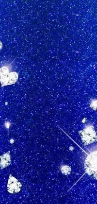 Get mesmerized by a glittery blue live wallpaper that showcases a heap of stars and hearts