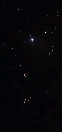 This stunning phone live wallpaper features a mesmerizing display of vibrant fireworks exploding against a dark night sky, with a unique and retro low-quality grainy effect