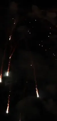 This phone live wallpaper showcases a breathtaking display of fireworks filling the sky with colors and lights