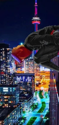 This live wallpaper features Spider-Man flying through a city at night, with the iconic CN Tower standing tall in the background