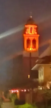 This live wallpaper features a captivating scene of buildings nestled together, with torches intensifying the orange fog
