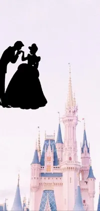 Enjoy a romantic fairytale on your phone with this live wallpaper featuring a silhouette kiss in front of a beautiful castle inspired by animation