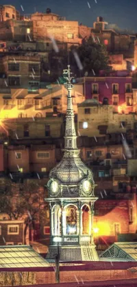 This live wallpaper features a compelling image of a clock tower situated on top of a building at night time captured through a tilt-shift photo technique