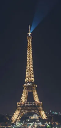 This phone live wallpaper showcases a beautiful image of the Eiffel Tower at night, beautifully lit up against the dark sky