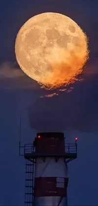 This phone live wallpaper depicts a striking red and white lighthouse against a full moon in the background