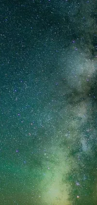 This phone live wallpaper showcases a bright Milky Way glowing in a green smoggy sky