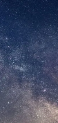 Looking for an enchanting live wallpaper for your phone? Check out this mesmerizing option featuring a stunning night sky filled with glimmering stars