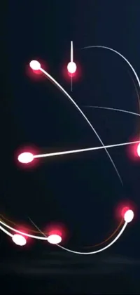 This phone live wallpaper showcases a close up of a clock with red lights against a black background