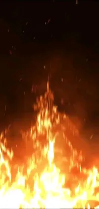This phone live wallpaper features a dramatic scene of a raging fire in a dark sky