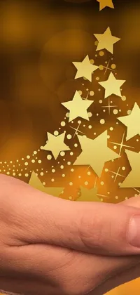 This phone live wallpaper features a beautiful Christmas tree against a golden background with sparkling stars
