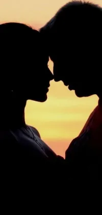 Experience a romantic sunset through your phone with this beautiful live wallpaper silhouette