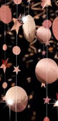 This phone live wallpaper features a captivating design with hanging balls and stars in rose gold on a cosmos backdrop that adds a sense of wonder and enchantment